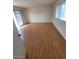 Bright bedroom with wood flooring, white walls, a sliding glass door, and window at 3797 Monument St, Las Vegas, NV 89121