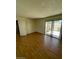Bedroom showcases wood flooring, neutral walls, and sliding glass door at 3797 Monument St, Las Vegas, NV 89121