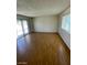Bedroom featuring wood-look floors, natural light, and a sliding glass door at 3797 Monument St, Las Vegas, NV 89121