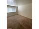 Standard bedroom features a neutral-colored carpet, a window, and basic finishes at 3797 Monument St, Las Vegas, NV 89121