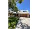 Charming front exterior featuring a two car garage and beautiful landscaping at 3797 Monument St, Las Vegas, NV 89121