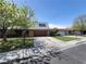 Charming single-story home features a brick facade, mature tree, and a two-car garage at 3797 Monument St, Las Vegas, NV 89121