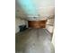 Spacious garage featuring a wooden garage door, concrete flooring and plenty of storage at 3797 Monument St, Las Vegas, NV 89121