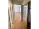 Hallway features wood flooring, mirrored closet, and doors to other rooms at 3797 Monument St, Las Vegas, NV 89121