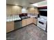 Well-lit kitchen with wooden cabinets, tile countertops, stainless steel dishwasher, and modern appliances at 3797 Monument St, Las Vegas, NV 89121