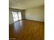 Open-plan living room featuring sliding glass doors to the outdoors and wood flooring at 3797 Monument St, Las Vegas, NV 89121