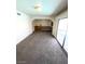 Open-concept living area featuring sliding glass doors to backyard, carpet flooring and neutral paint at 3797 Monument St, Las Vegas, NV 89121