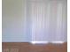 Bright living room with vertical blinds and hardwood flooring at 3797 Monument St, Las Vegas, NV 89121