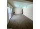 Spacious living room with sliding glass doors to the backyard, carpet flooring and neutral wall paint at 3797 Monument St, Las Vegas, NV 89121
