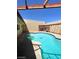Private backyard pool with a tanning shelf, surrounded by a patio, perfect for relaxation at 3797 Monument St, Las Vegas, NV 89121