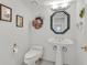 Classic half-bathroom featuring a pedestal sink, framed mirror, and complementary fixtures at 3938 E Russell Rd, Las Vegas, NV 89120