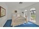 Cozy bedroom with a quaint bed, arched windows, and a peaceful view of the outdoors at 3938 E Russell Rd, Las Vegas, NV 89120
