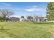 A sprawling property with a large green lawn and elegant white home featuring arched windows at 3938 E Russell Rd, Las Vegas, NV 89120