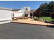 A white stucco home featuring arched windows, red tile roof, mature trees and meticulous landscaping at 3938 E Russell Rd, Las Vegas, NV 89120