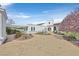 Beautiful white home with a terracotta roof, brick driveway, and meticulously landscaped garden at 3938 E Russell Rd, Las Vegas, NV 89120