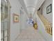Bright hallway with tile floors, curved ceilings, and staircase with golden handrail at 3938 E Russell Rd, Las Vegas, NV 89120