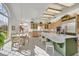A sunny eat-in kitchen features stainless steel appliances, an island, and white tile floors at 3938 E Russell Rd, Las Vegas, NV 89120