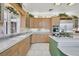Well-lit kitchen featuring tile floors, stainless steel appliances, and wooden cabinets at 3938 E Russell Rd, Las Vegas, NV 89120