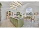Bright eat-in kitchen features white tile floors, stainless steel appliances, and an island with a cooktop at 3938 E Russell Rd, Las Vegas, NV 89120