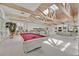 Open concept living room with vaulted ceilings, skylights, bar, and pool table at 3938 E Russell Rd, Las Vegas, NV 89120
