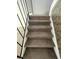 Carpeted staircase with black railing and marbled wall at 4363 Spencer St # 8, Las Vegas, NV 89119