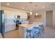Bright kitchen with white cabinets, stainless steel appliances, and large island with seating for three at 4400 E Cactus Canyon Dr, Pahrump, NV 89061