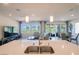 Modern kitchen island overlooking the spacious living room with lots of natural light and golf course views at 4400 E Cactus Canyon Dr, Pahrump, NV 89061