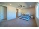 Bright main bedroom with neutral paint, ceiling fan, and large windows at 4400 E Cactus Canyon Dr, Pahrump, NV 89061