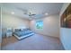 Spacious bedroom with plush carpet, ceiling fan, and ample natural light at 4400 E Cactus Canyon Dr, Pahrump, NV 89061