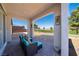 Cozy covered patio featuring comfortable seating and a view of the lush green landscape at 4400 E Cactus Canyon Dr, Pahrump, NV 89061