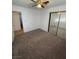 Bedroom with large, mirrored closet and ceiling fan at 4508 W San Miguel Ave, North Las Vegas, NV 89032