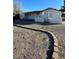 View of the home featuring a gravel yard, brick border, and partial view of the front facade at 4508 W San Miguel Ave, North Las Vegas, NV 89032