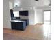 View of the kitchen with a tile floor, tile backsplash, dark blue cabinets, and a breakfast bar at 4508 W San Miguel Ave, North Las Vegas, NV 89032