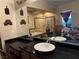Bathroom with a framed mirror, granite counters, and shower over tub at 4738 Laurel Canyon St, Las Vegas, NV 89129