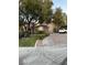 Single-story home featuring a well-maintained lawn, mature trees, and a paved driveway at 4738 Laurel Canyon St, Las Vegas, NV 89129