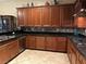 Spacious kitchen boasting wood cabinets, granite countertops, stainless steel appliances, and tile flooring at 4738 Laurel Canyon St, Las Vegas, NV 89129