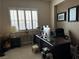 Bright office space with a large window, desk, and dark wood accents at 4738 Laurel Canyon St, Las Vegas, NV 89129