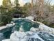 Backyard pool and hot tub with rock waterfall feature and seating area at 4738 Laurel Canyon St, Las Vegas, NV 89129