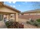 Covered patio with outdoor seating in backyard featuring desert landscaping and privacy wall at 4755 Rossini St, Pahrump, NV 89061