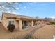 Spacious backyard with desert landscaping, a covered patio, and privacy provided by perimeter walls at 4755 Rossini St, Pahrump, NV 89061
