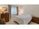 Comfortable bedroom with a queen bed, wooden dresser, and soft lighting from the bedside lamp at 4755 Rossini St, Pahrump, NV 89061