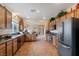 Well-lit kitchen showcasing granite countertops, wood cabinets, and a seamless flow into the adjacent dining area at 4755 Rossini St, Pahrump, NV 89061