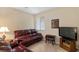 Inviting living room with a plush leather sofa, a modern television, and neutral wall colors at 4755 Rossini St, Pahrump, NV 89061