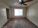 This bedroom is airy, featuring neutral walls, carpet, and a window at 4795 Via San Andros, Las Vegas, NV 89103
