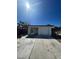 A single Gathering home with a long driveway, attached garage and a carport on a sunny day at 4795 Via San Andros, Las Vegas, NV 89103