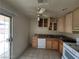 Functional kitchen with tiled floors, light wood cabinets, and white appliances at 4795 Via San Andros, Las Vegas, NV 89103
