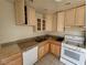 Kitchen featuring light wood cabinets, granite countertops, and white appliances at 4795 Via San Andros, Las Vegas, NV 89103