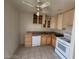 Functional kitchen with tiled floors, light wood cabinets, and white appliances at 4795 Via San Andros, Las Vegas, NV 89103