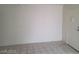 A simple living room with tile floor offers a view of the front door at 4795 Via San Andros, Las Vegas, NV 89103