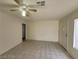 A bright living room features tile flooring and a ceiling fan at 4795 Via San Andros, Las Vegas, NV 89103